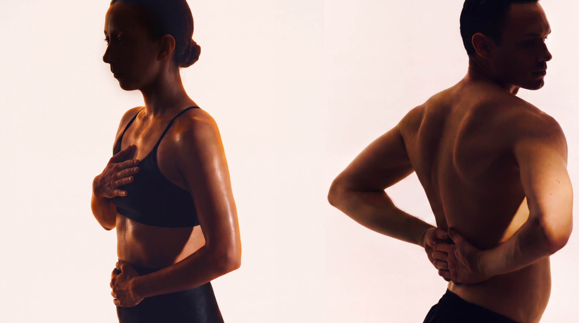 Two athletes using mobility tools in an amber-lit training space
